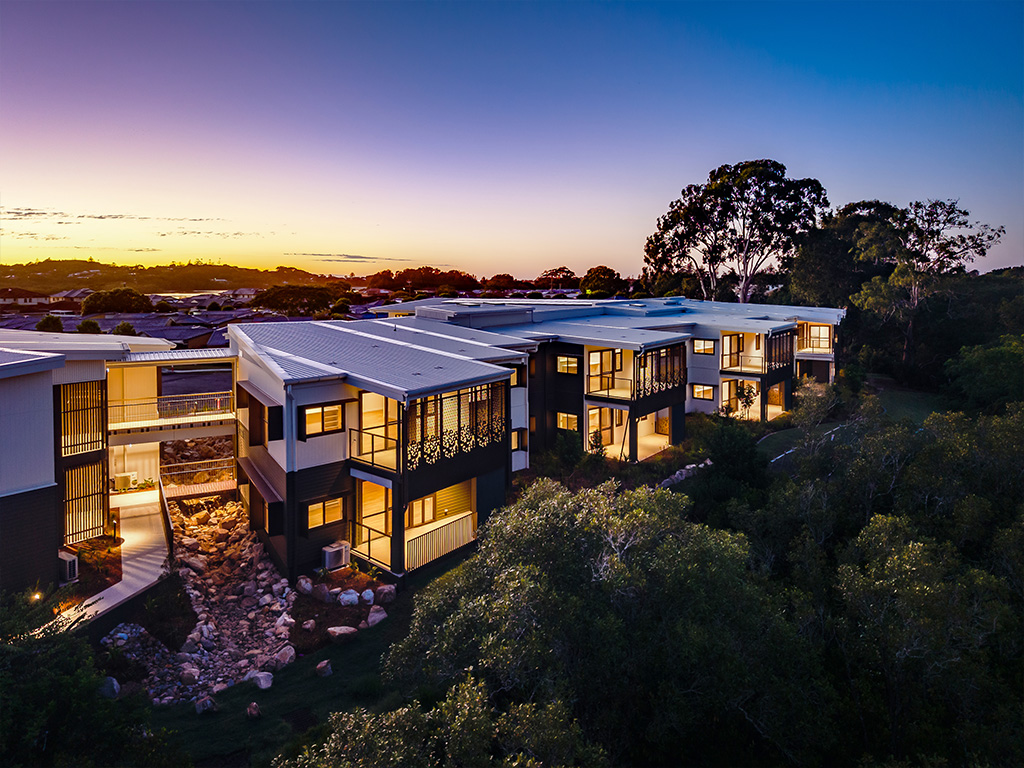 outdoor sunset aerial photo of Assisi Apartments with North Creek in background
